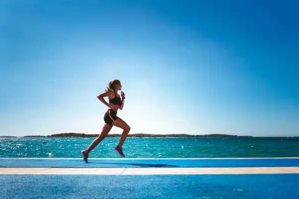 Woman running showing strong leg muscle Welwyn Garden City